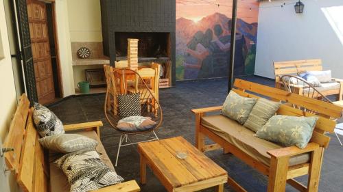 a living room with wooden furniture and a fireplace at MillaUno Hostel in Córdoba