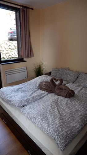 a bedroom with a bed with a towel on it at Apartmán Daniela in Bansko
