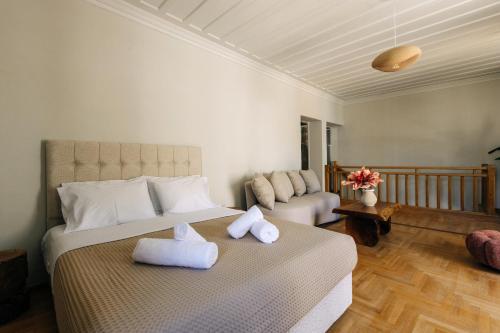 a bedroom with a bed with towels on it at Mesta Grand Residence in Chios