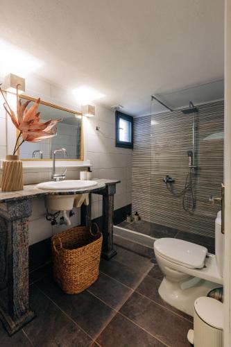 a bathroom with a sink and a toilet and a shower at Mesta Grand Residence in Chios