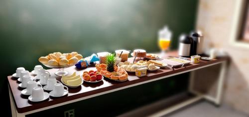 a table with a variety of food on it at LD Hotel in Três Lagoas