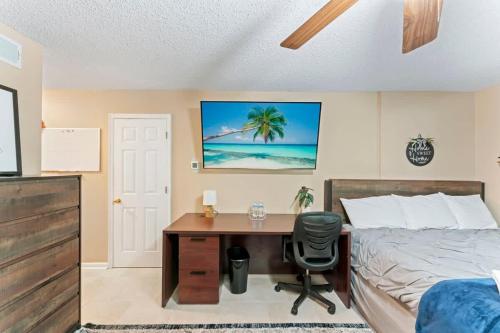 a bedroom with a desk and a bed and a bed and a desk at Mid-Century Studio Kitchenette Wi-Fi in Jacksonville