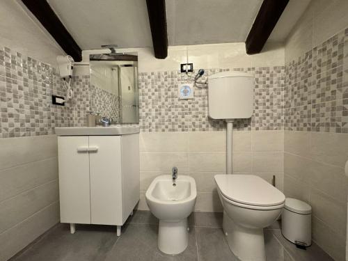 a bathroom with a toilet and a sink at Premium Venice Residence in Mestre