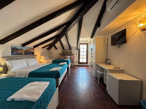 a room with three beds and a television in it at Premium Venice Residence in Mestre