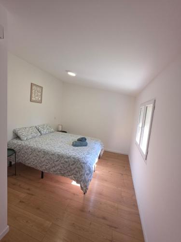 a bedroom with a bed in a white room at T2 proche gare & centre ville climatisé in Castres