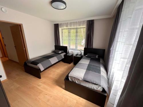 a bedroom with two beds and a window at Roosi Kodumajutus in Pärnu