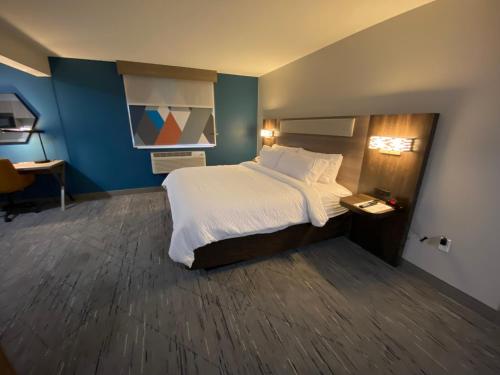 a hotel room with a bed and a desk at Holiday Inn Express Bluffton by IHG in Bluffton