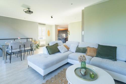 a living room with a couch and a table at Duplex de Bandol - Plages et port à pied in Bandol