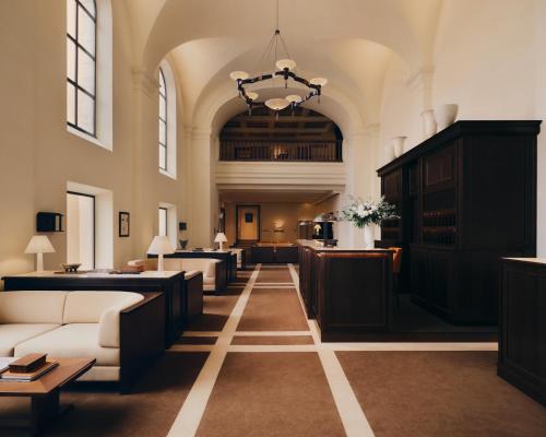 a large room with couches and tables in a building at Villa Florentine, A Beauvallon Hotel & Spa in Lyon