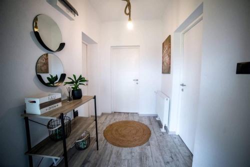 a living room with a table and a mirror at Bara Apartment and Studio in Gheorgheni