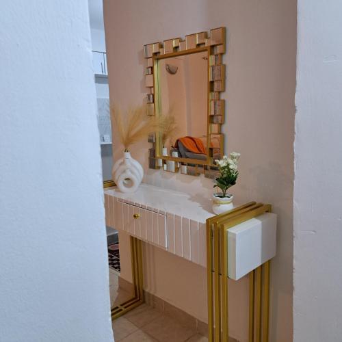a bathroom with a sink and a mirror at RyNa Homes in Meru