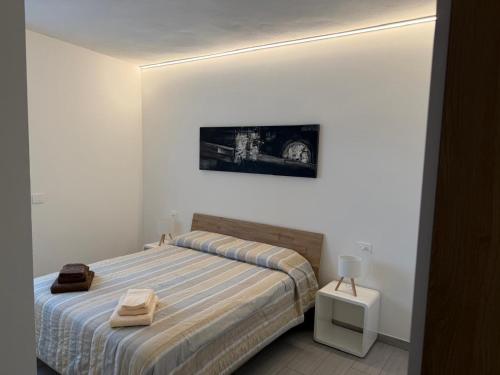 a bedroom with a bed and a picture on the wall at Bellavista-Verceia in Verceia