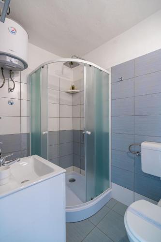 a bathroom with a shower and a sink at Lumina Apartments in Korčula