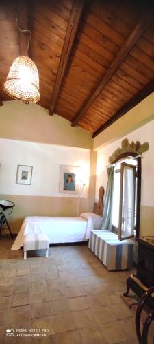 a bedroom with a bed and a table in a room at Il Borghetto Country Charme in Cefalù