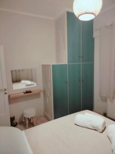 a bedroom with a bed and a green cabinet at Captain's House in Filiatra