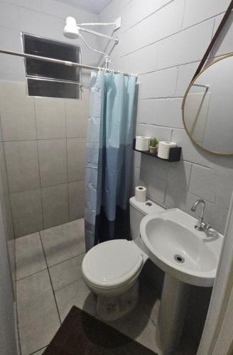 a bathroom with a toilet and a sink at Kitnet Completa em Cotia com Garagem 04 in Cotia