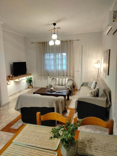 a living room with a couch and a table at Captain's House in Filiatra
