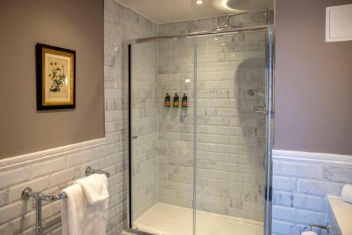 a bathroom with a shower with a glass door at The Globe, Warwick, Warwickshire - Brunning & Price in Warwick