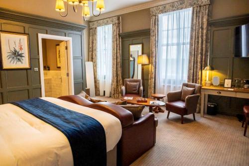 a hotel room with a bed and a living room at The Globe, Warwick, Warwickshire - Brunning & Price in Warwick