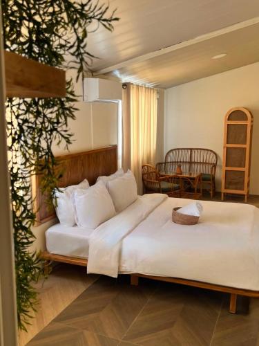 a large white bed in a room with a table at Sukoun Studios in Baalbeck