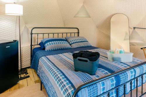 a bedroom with a bed with a suitcase on it at Peaceful Dome Getaway in the Catskills in Gilboa