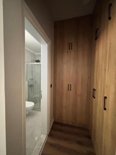 a bathroom with wooden cabinets and a white sink at Villa suit in Trabzon