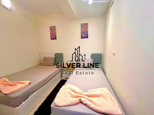 a room with two beds and a sign that readssilver linereal estate at Marassi in El Alamein