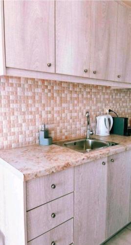a kitchen with a sink and a counter top at Sunset Paradise Oia in Oia