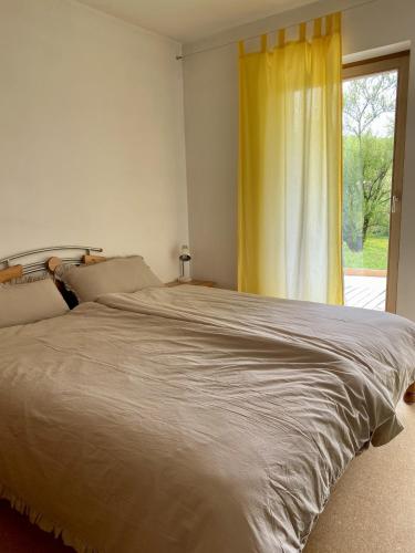 a bedroom with a large bed and a window at Apartment with Terrace & Garden View in Zwiesel