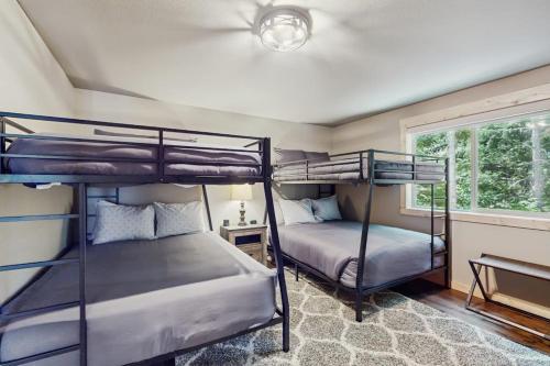 two bunk beds in a room with a window at Paintbrush Haven in Ronald