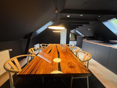 a wooden table with chairs in a kitchen at 4SEASONS - Amber Spring Suite in Aalborg