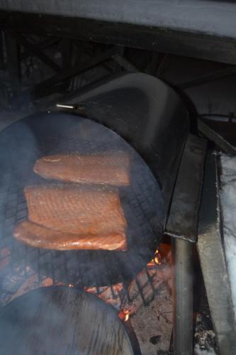 three sausages are cooking on a grill at Guesthouse Torppa in Korkeakoski