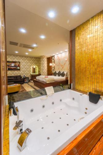 a large bathroom with a large white bath tub at Grand Canyon Hotel in Ankara