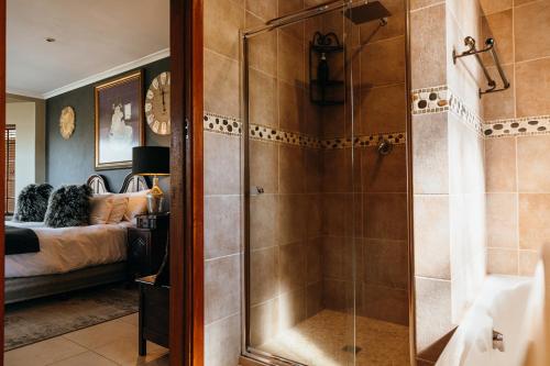a bathroom with a shower and a bedroom at Cwebile Guesthouse in Winterton