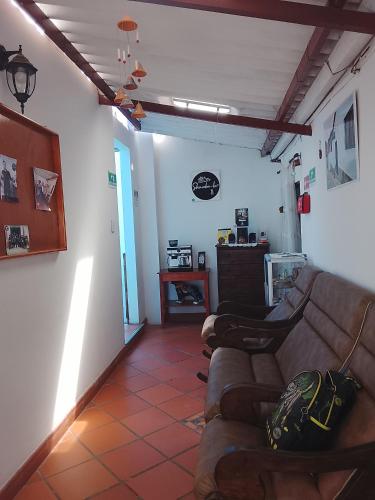 a living room with two couches and a table at Hostal familiar Shambala in Silos