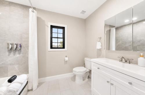 a white bathroom with a toilet and a sink at Private 1BR Apt, WiFi, Reliable, Near NYC in Scotch Plains