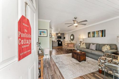a living room with a couch and a table at The Poolside Cottage -Wifi Pool in Jacksonville