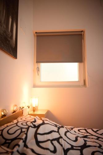 a bedroom with a bed and a window at Starview by MD apartments in Ljubljana