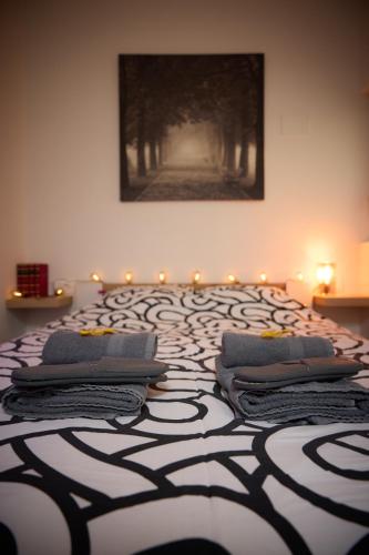 a large bed with pillows on top of it at Starview by MD apartments in Ljubljana