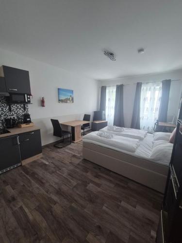 a bedroom with a bed and a table and chairs at Comfort Collection Waldviertel in Litschau
