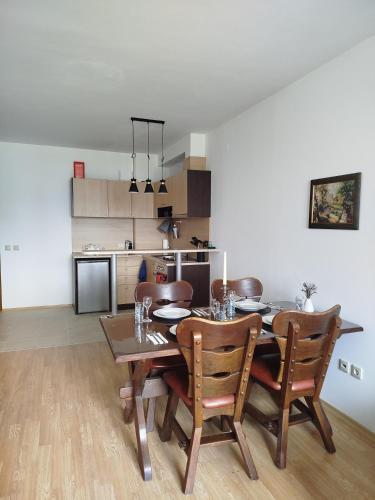 a kitchen and dining room with a table and chairs at Mountain Nest Pirin in Razlog
