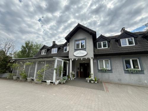 a large house with a driveway in front of it at Gosciniec Pod Brzozami in Poznań