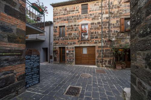 a brick building with a sign in front of it at La Casetta dei Forni in Radicofani