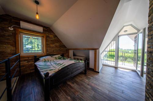 a bedroom with a bed and a large window at Casa Frida in Manđelos