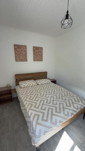 a bed in a white room with a bed sidx sidx sidx at Le petit port de boucain in Port-de-Bouc