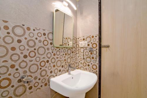 a bathroom with a white sink and a mirror at The Fortune Hotel, Newtown in New Town