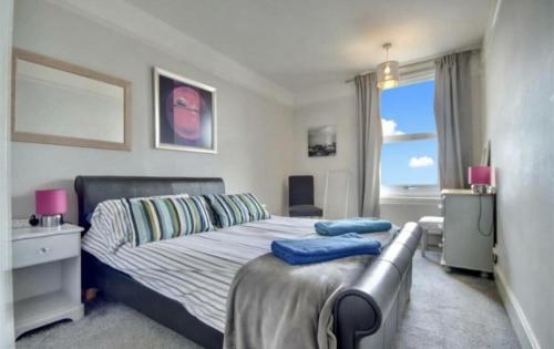 a bedroom with a bed and a couch and a window at Lennox Lodge 2 in Portsmouth