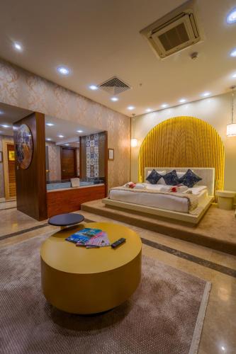 a bedroom with a large bed with a yellow headboard at Grand Canyon Hotel in Ankara