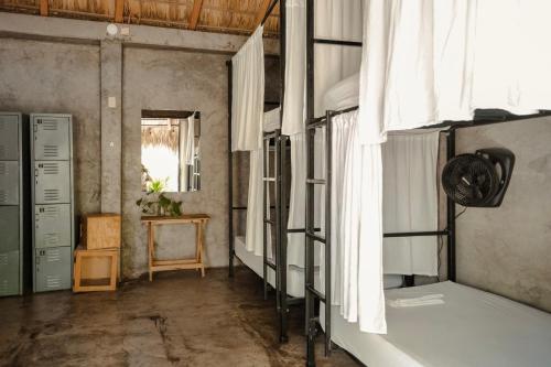 a room with a bed and a window at Puerto Dreams H in Puerto Escondido