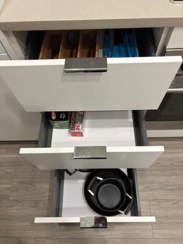 a white cabinet with a washing machine underneath it at Luxury Heart of the city in Surrey